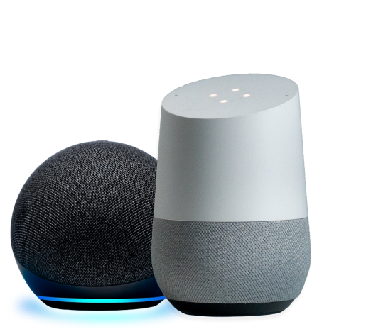 An Amazon Echo smart speaker, charcoal in color, spherical in shape with a blue light ring; Google Home smart speaker with a white and gray cylindrical design.
